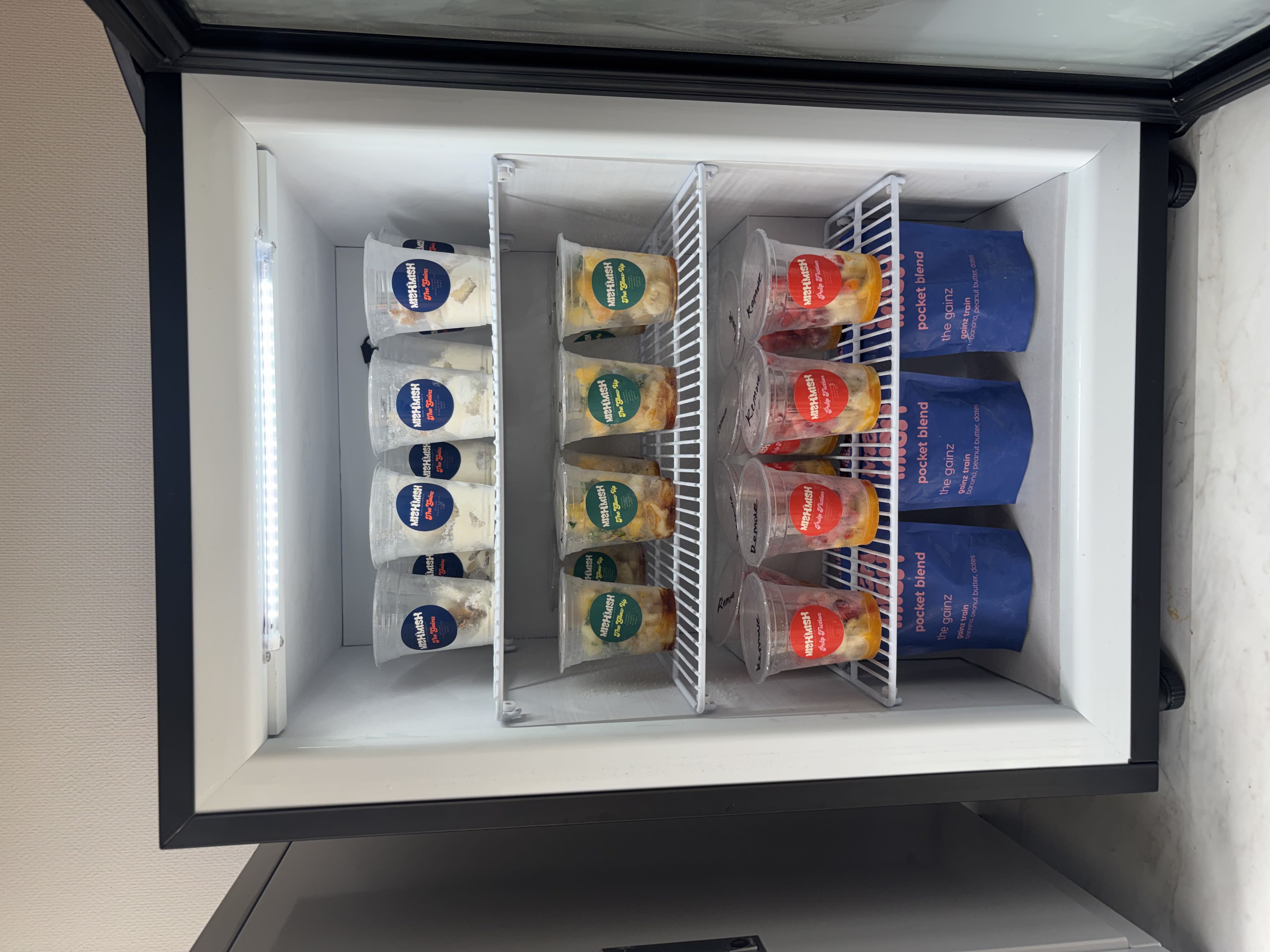MishMish fridge stocked with smoothie cups and pocket blends